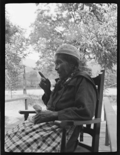 An unidentified Native American woman wearing basket on her head