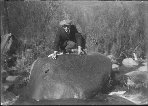 Rock with Indian petroglyph and unidentifed man