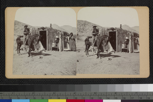 Hualapai Indian on horse and two Hualapai women next to house