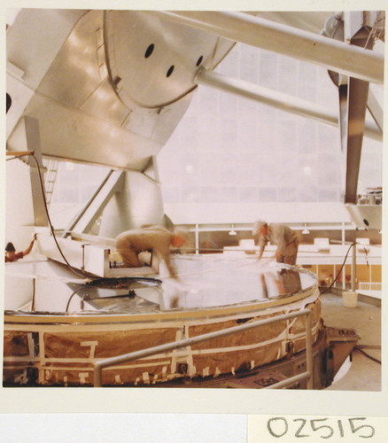 Workmen washing the 200-inch telescope mirror on the floor of the dome, Palomar Observatory