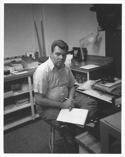 John Bedke seated on a photograph laboratory