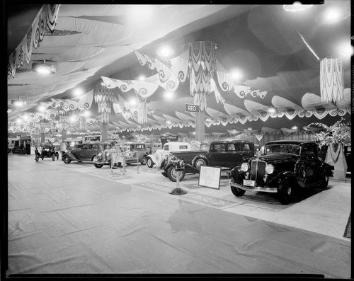 REO automobiles at an auto show. 1934