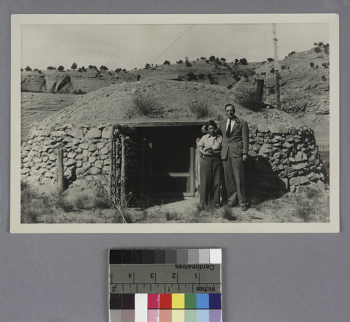 Grace Burke Hubble and Edwin Powell Hubble standing outside their hogan in Shonto, Arizona