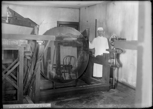 Charles I. Schrock with a 60-inch mirror blank at the Mount Wilson Observatory Optical laboratory, Pasadena