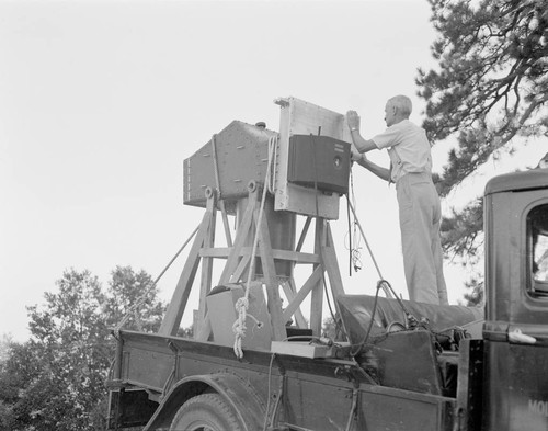 Astronomer with 100-inch focal length aerial camera, on Mount Wilson