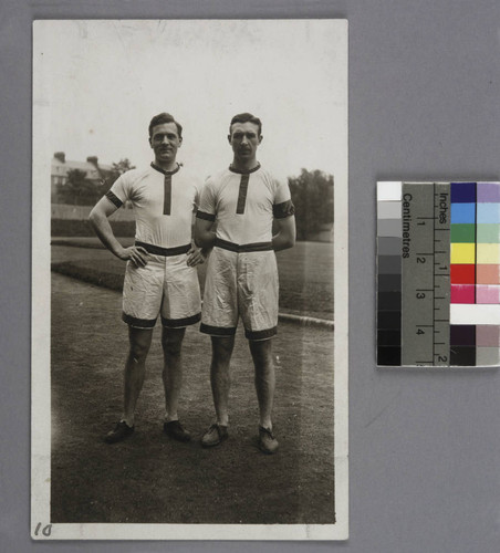 Edwin Powell Hubble and William Ziegler in track team uniforms, standing on a running track