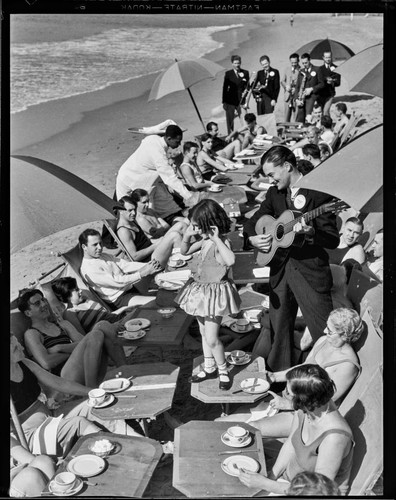 Young girl dancing on table during food service on the beach, Deauville Club in Santa Monica