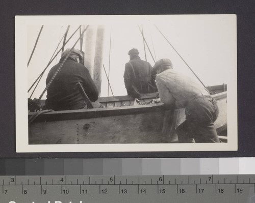 Three men with boat