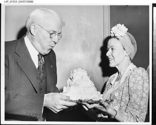 Harry Chandler blowing out candles on his 77th birthday