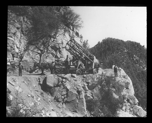 Metal tube of the 60-inch telescope being transported along a road on Mount Wilson