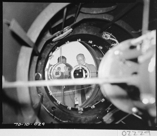 Harold Brown and Caryl Haskins reflected in the mirror of the 60-inch telescope, Palomar Observatory