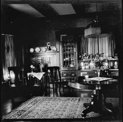 Unidentified house interior with flowers on table