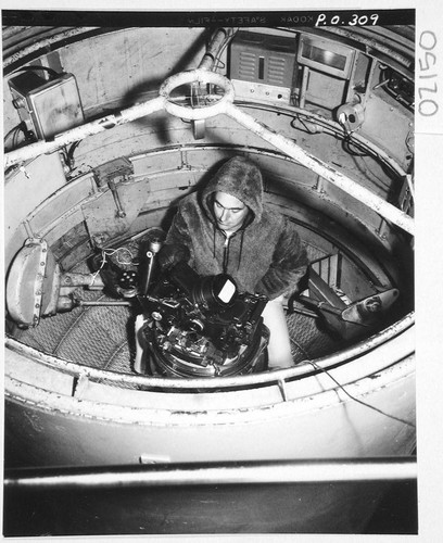 Halton C. Arp at the 200-inch telescope prime-focus spectrograph in a cage, Palomar Observatory