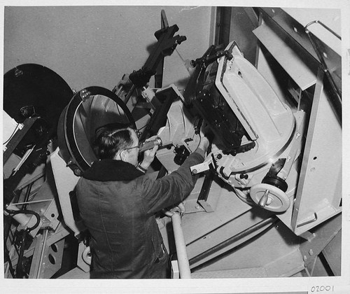 Horace Babcock making adjustments to the 200-inch telescope coude cameras, Palomar Observatory