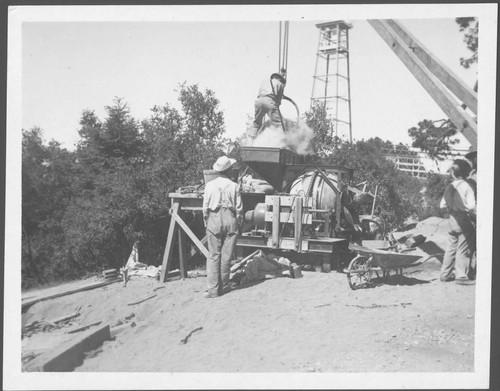 Concrete mixer and construction workers, building a water reservoir on Mount Wilson