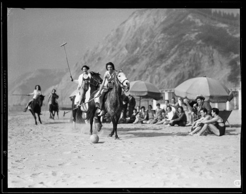 Women playing polo on the beach in Santa Monica