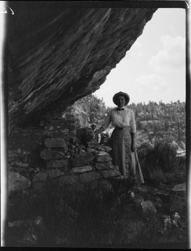 Grace Nicholson at a cliff dwelling in a canyon of the Southwest