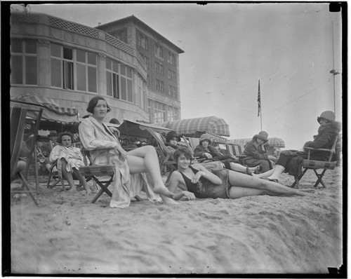 Swim team in beach chairs in front of the Club Casa del Mar, Santa Monica, California