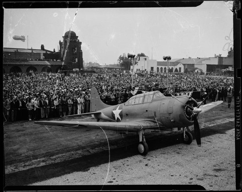 World War II-era warplane at L.A. Municipal Airport with barrage balloon