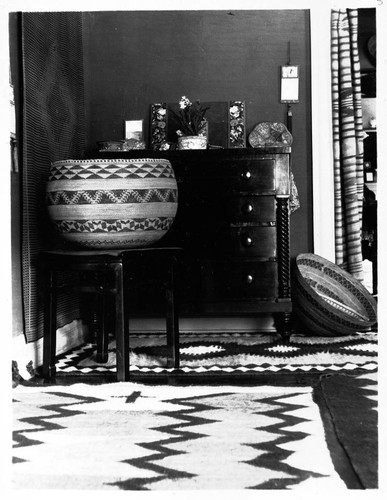 Interior of Grace Nicholson's house and store, showing Indian baskets and rugs