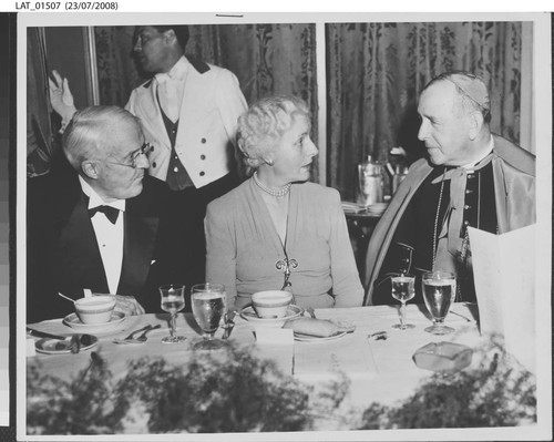 Archbishop John J. Cantwell speaks with Harry Chandler and Mrs. Cortlandt Parker