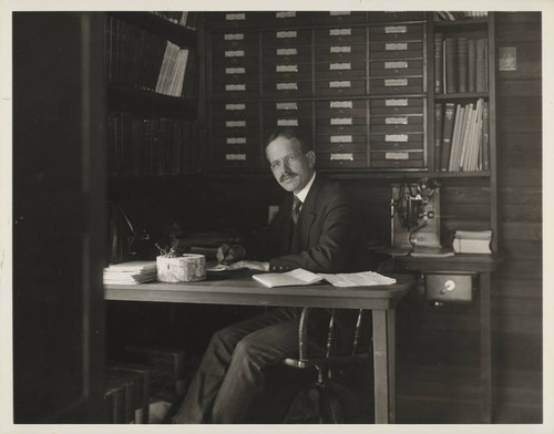 George Ellery Hale, seated at his office desk at the Monastery at Mount Wilson Observatory