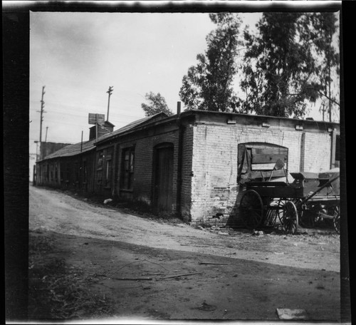 Alley and wooden wagon near 225 San Pedro Street, Los Angeles