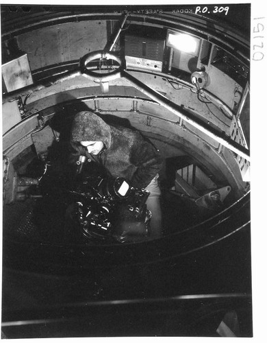 Halton C. Arp at the 200-inch telescope prime-focus spectrograph in a cage, Palomar Observatory