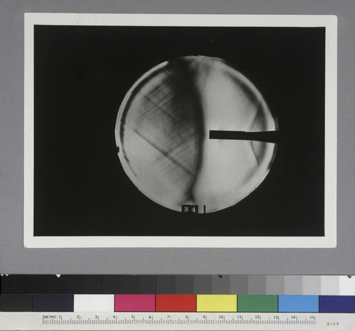 Shadow photograph of wind tunnel test results, showing air stream from a cylindrical model