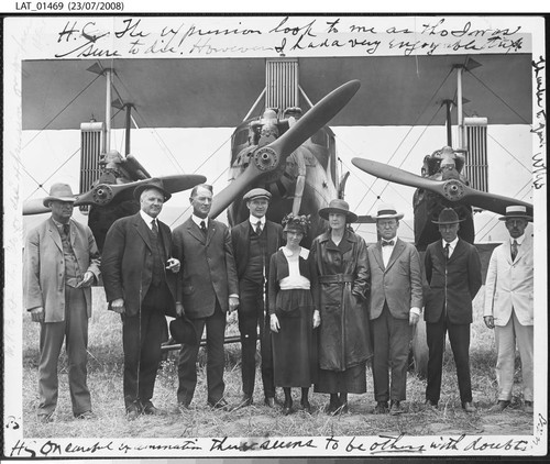 Harry Chandler posed with others in front of an airplane