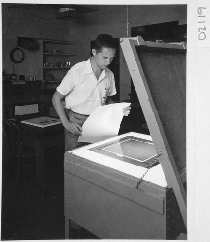 Hendrik Rubingh standing at a contact printer for sky survey atlas prints