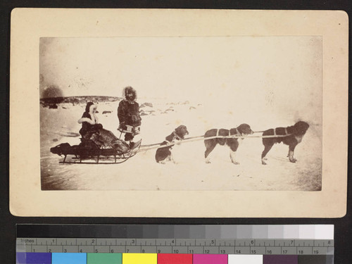 2 men with dog sled and dogs