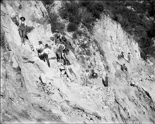 Asian construction workers widening the toll road below Pasadena Gap, Mount Wilson