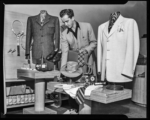 Interior view of men's store with merchandise and employee, Corrine Griffith Shop, Beverly Hills