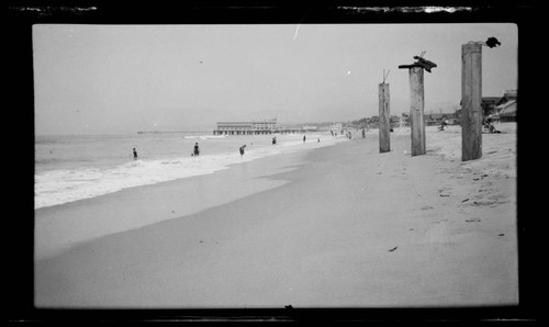 View of beach with short pier in distance, Santa Monica