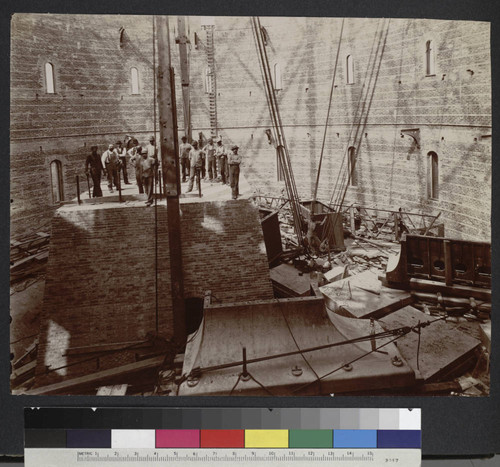 Construction workers standing on the completed base for the 40-inch telescope at Yerkes Observatory