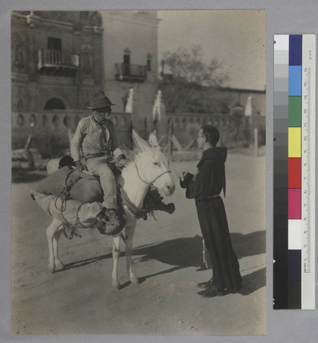 Prospector and a priest in front of Mission San Xavier del Bac, Tucson, Arizona