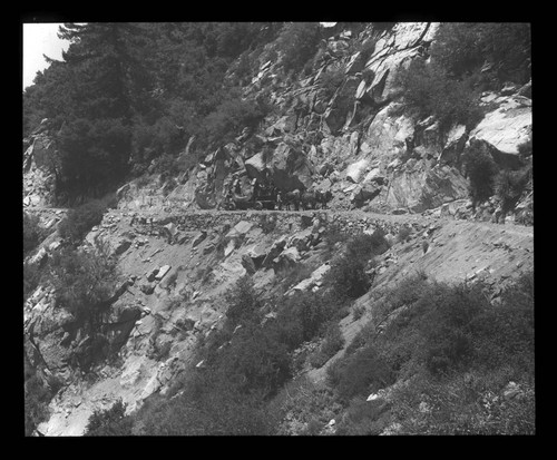 Yoke of the 60-inch telescope mounting being transported up a road on Mount Wilson