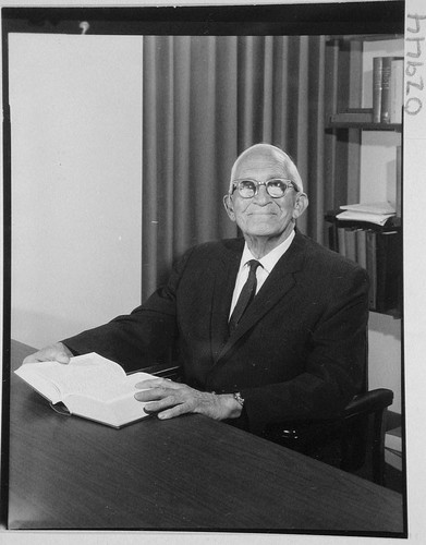 Alfred H. Joy, seated at his desk