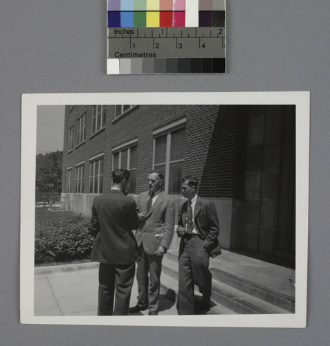 Edwin Powell Hubble and two unidentified men outside a building at the U.S. Army Ballistic Research Laboratory