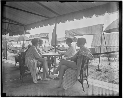 Swim team at a table at the Club Casa del Mar, Santa Monica, California