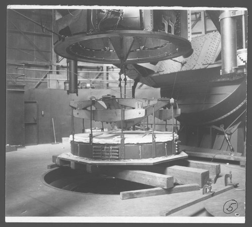 The 100-inch mirror and hoisting device, resting on a raised platform above the silvering hole, Mount Wilson Observatory