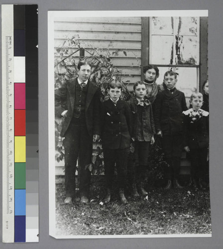 Edwin Powell Hubble, as a child, and his cousins, posing for a portrait outside of a building