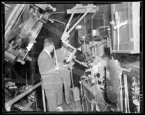 Mr. Wilson and Mr. Nichols standing with the 100-inch telescope Coude spectrograph, Mount Wilson Observatory