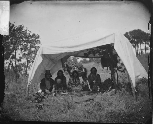 Wolf on the Hill and wife [left] and Little Bear and wife [right]. Cheyennes in camp at Grand Council, Okmulgee 1875