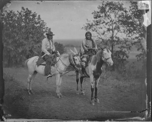 Bear Robe and wife, Arapaho. Horseback. Full blood. Indian Territory