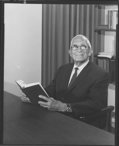 Alfred H. Joy, seated at his desk