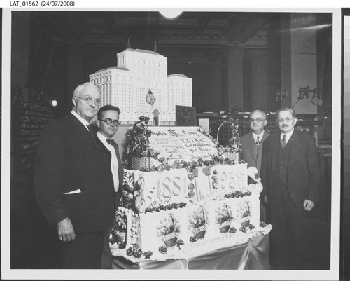 Harry Chandler posed with cake at the 50th anniversary of the Los Angeles Times