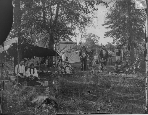 Temporary Cheyenne camp during Grand Council meeting, 1875. At left, interpreter Philip McClusker and his Cheyenne Indian wife, Minnehaha