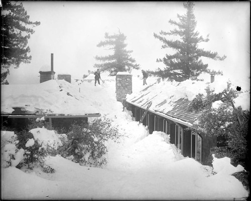 Shoveling snow from the roof of the monastery, Mount Wilson Observatory